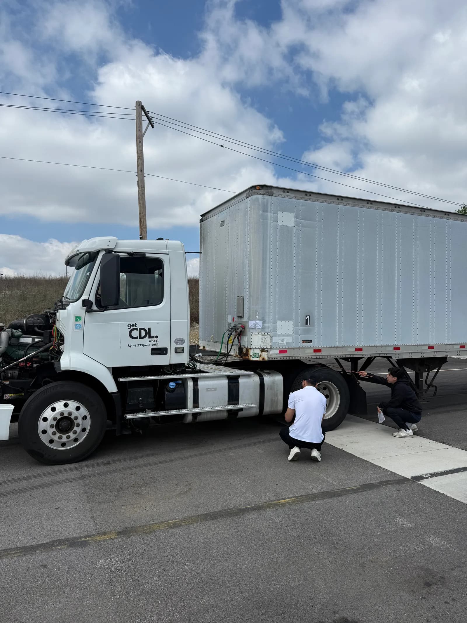 Student inspecting a training truck during CDL class